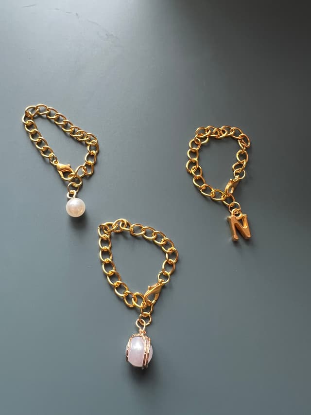 Gold initial, pearl with gold, and simple pearl charm varieties