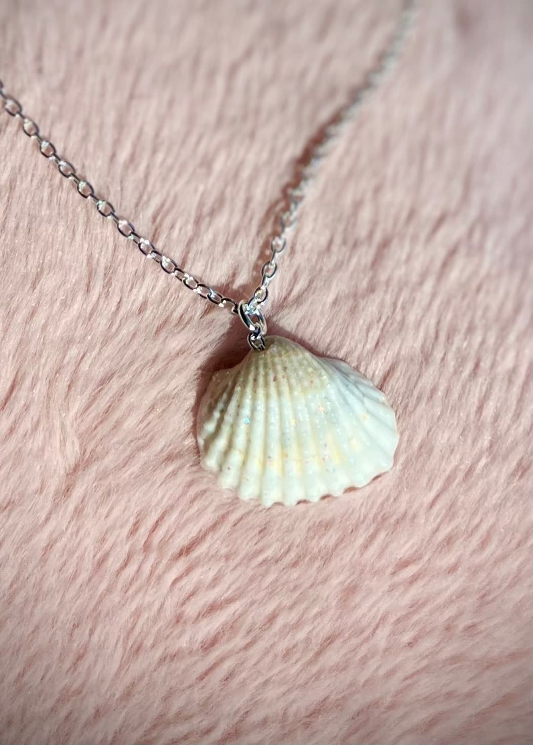 Sparkling seashell pendant close-up on silver chain